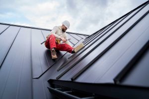 Roofer working on a metal roof installation.