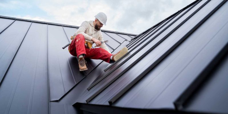 Roofer working on a metal roof installation.